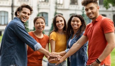 Students Community. Group Of Happy College Friends Joining Hands Together Outdoors